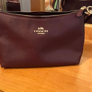 Purple Coach purse with strap